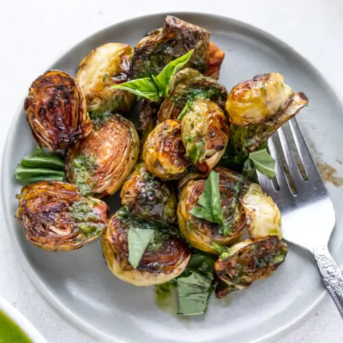 balsamic roasted brussels sprouts garnished with basil leaves