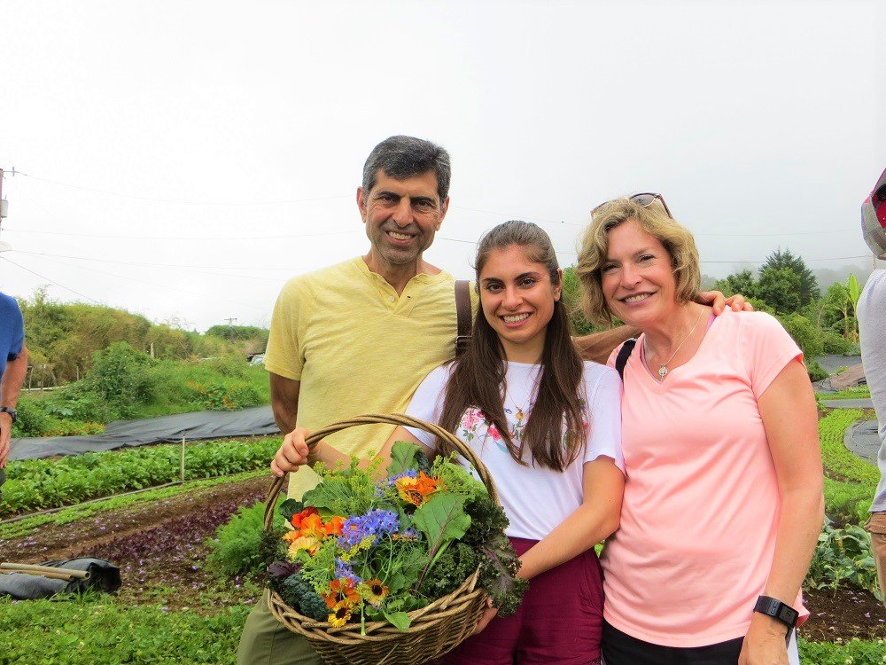 monica nedeff and her parents with salad greens and edible flowers