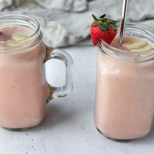 two fruit smoothies in glass mugs