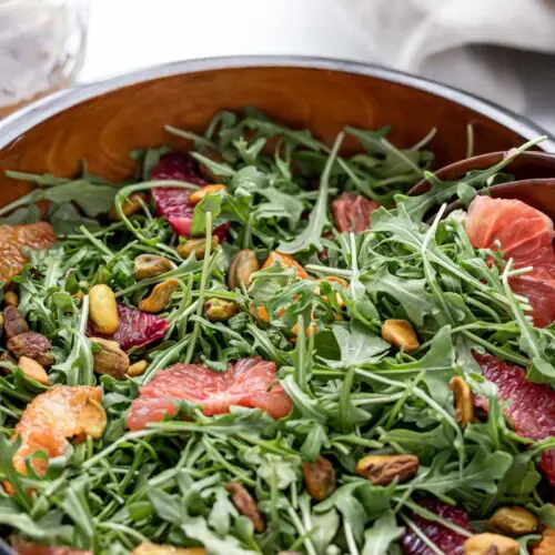 large salad bowl of arugula and segmented citrus fruit