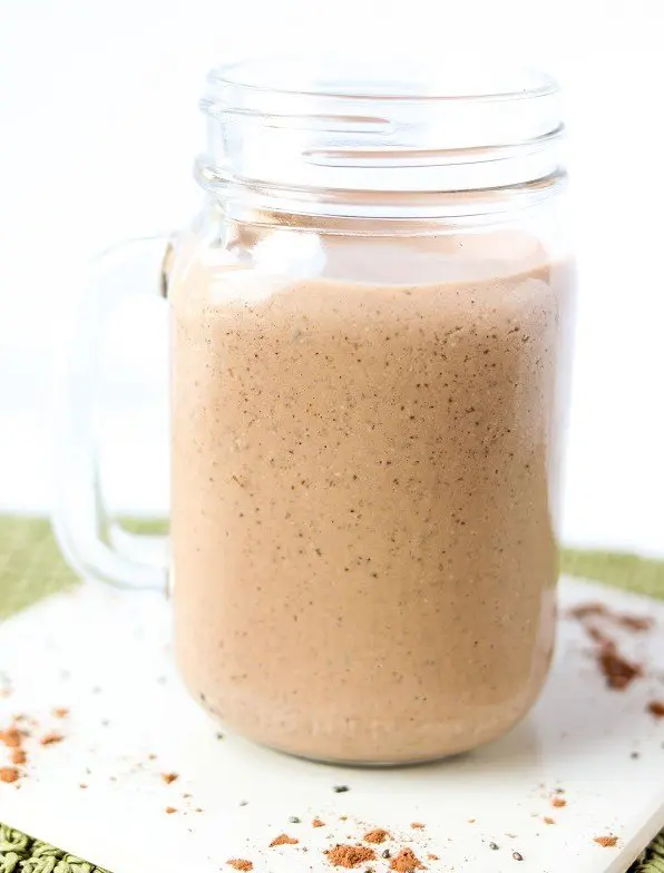 chocolate smoothie with ground chia seeds in a clear mug