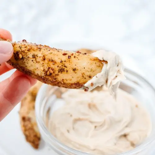 close up of a hand holding a single zaatar fry