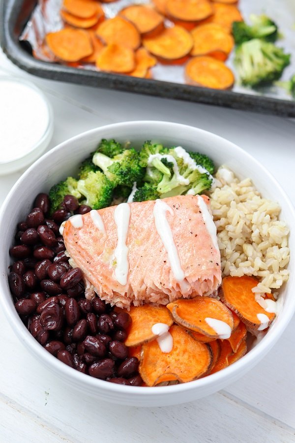 maple glazed salmon buddha bowl drizzled in maple tahini dressing