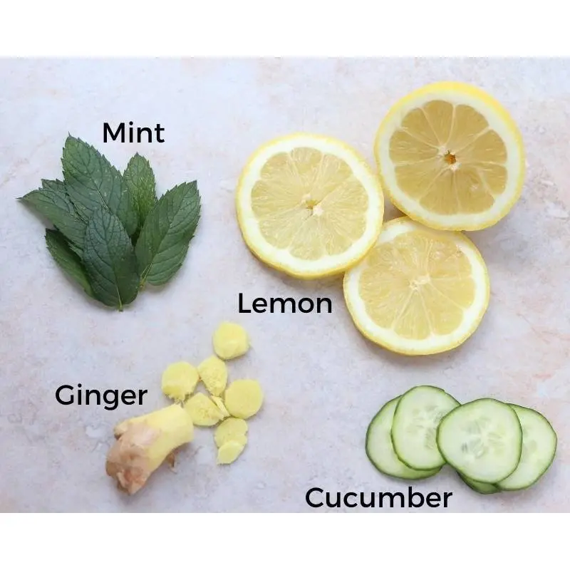 overhead display of mint leaves and sliced ginger, cucumber and lemon