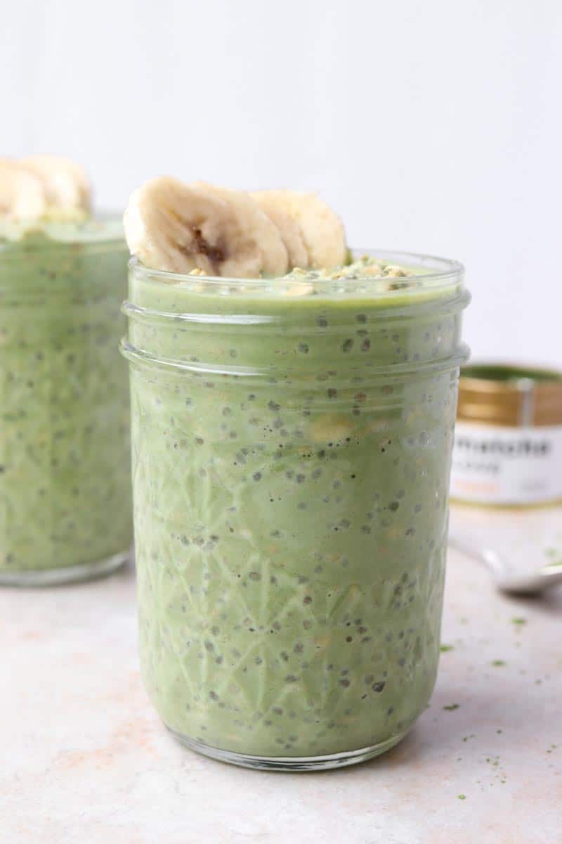 Close up of a glass jar of green overnight oats with chia seeds 