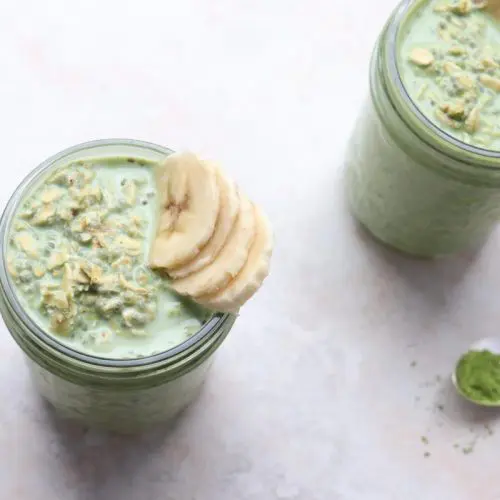 jar of overnight oats with a spoon of matcha powder next to it