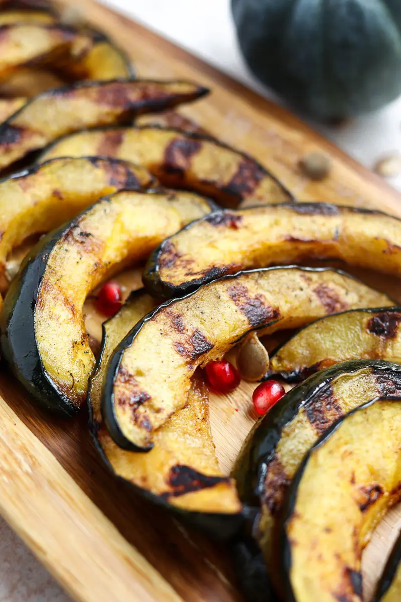 grilled acorn squash slices with pomegranate seeds