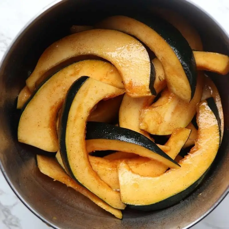 acorn squash slices covered in maple syrup, cinnamon, cayenne pepper and paprika