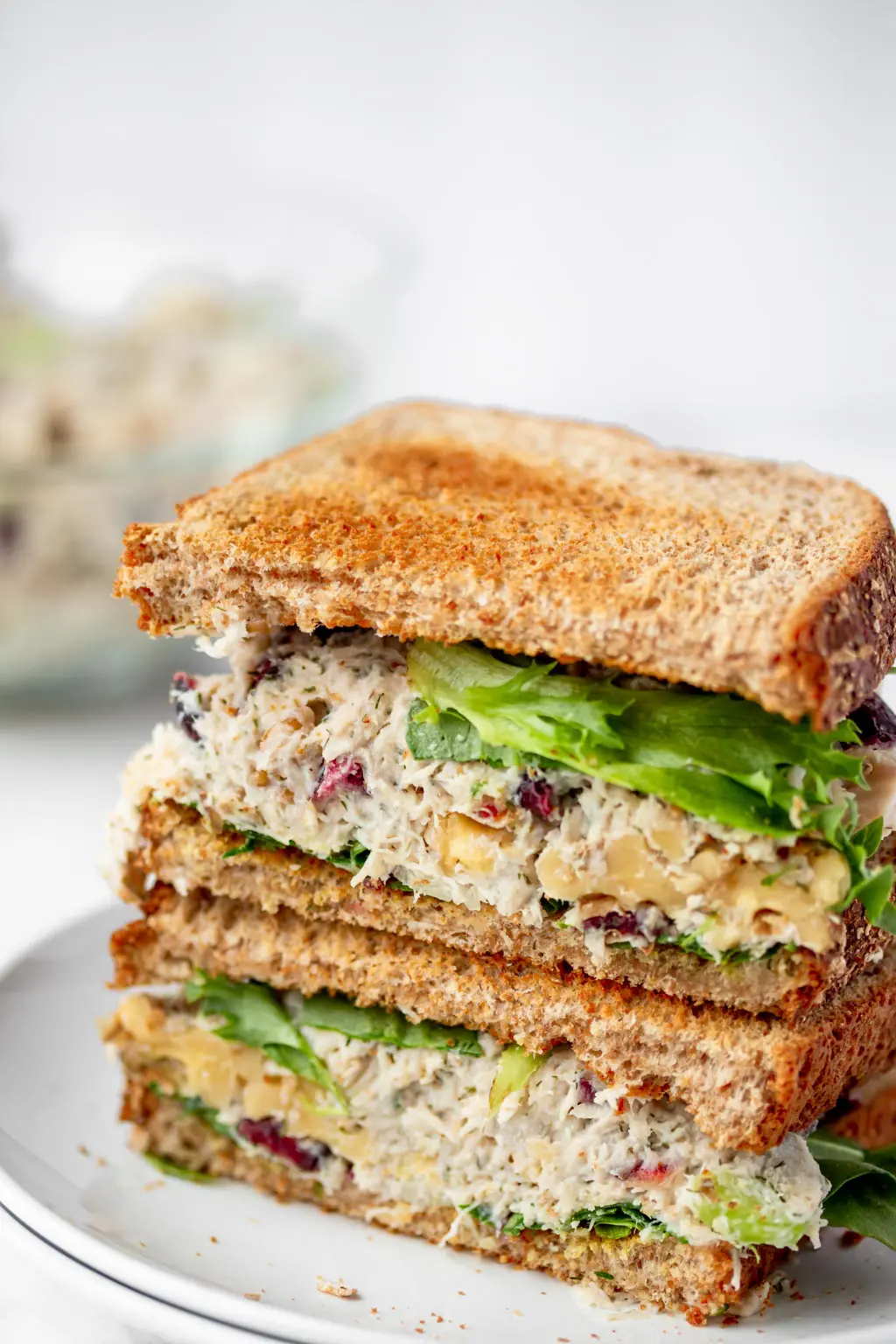 two chicken sandwich halves stacked  on a plate