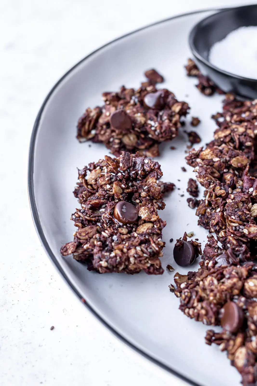 granola on a plate with chocolate and sea salt on top