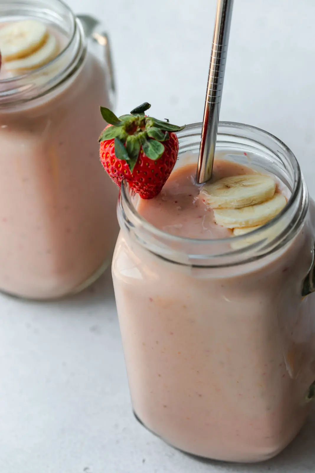 Strawberries and bananas garnish the smoothie