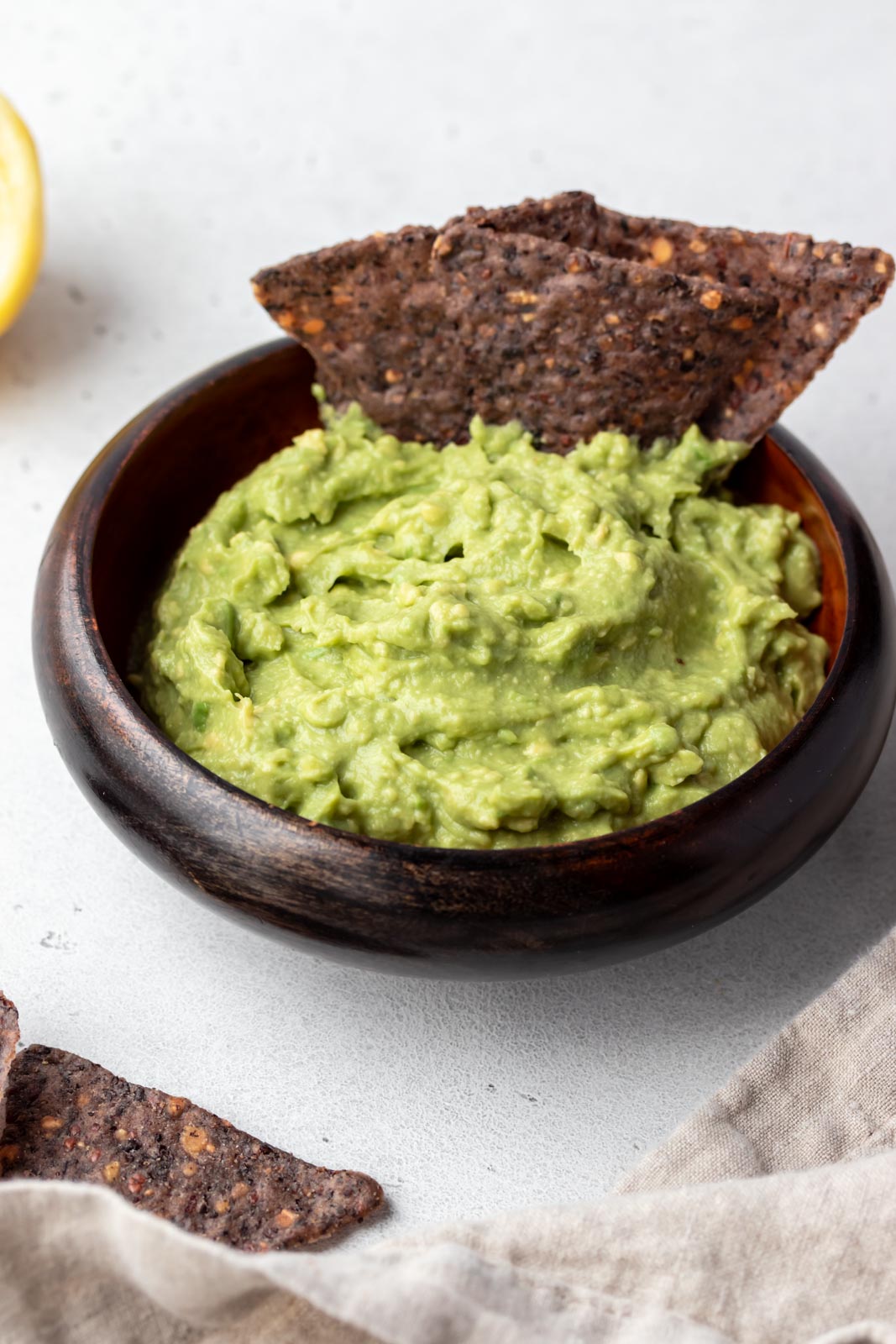 chips sitting in a bowl of guacamole