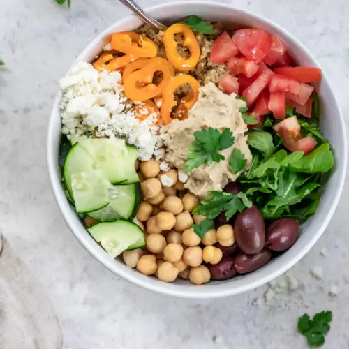 arugula, cucumber, tomatoes in a buddha bowl