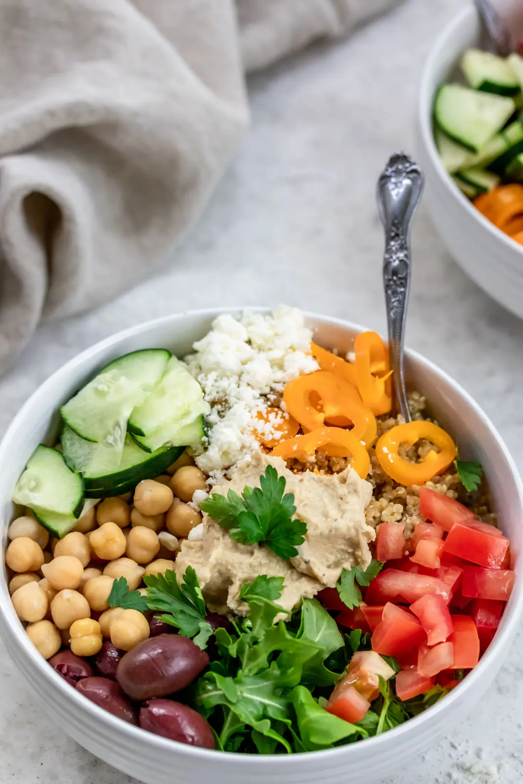 bowl of chickpeas, hummus, quinoa and vegetables