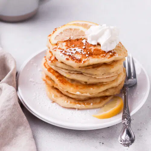 lemon pancakes stacked on plate