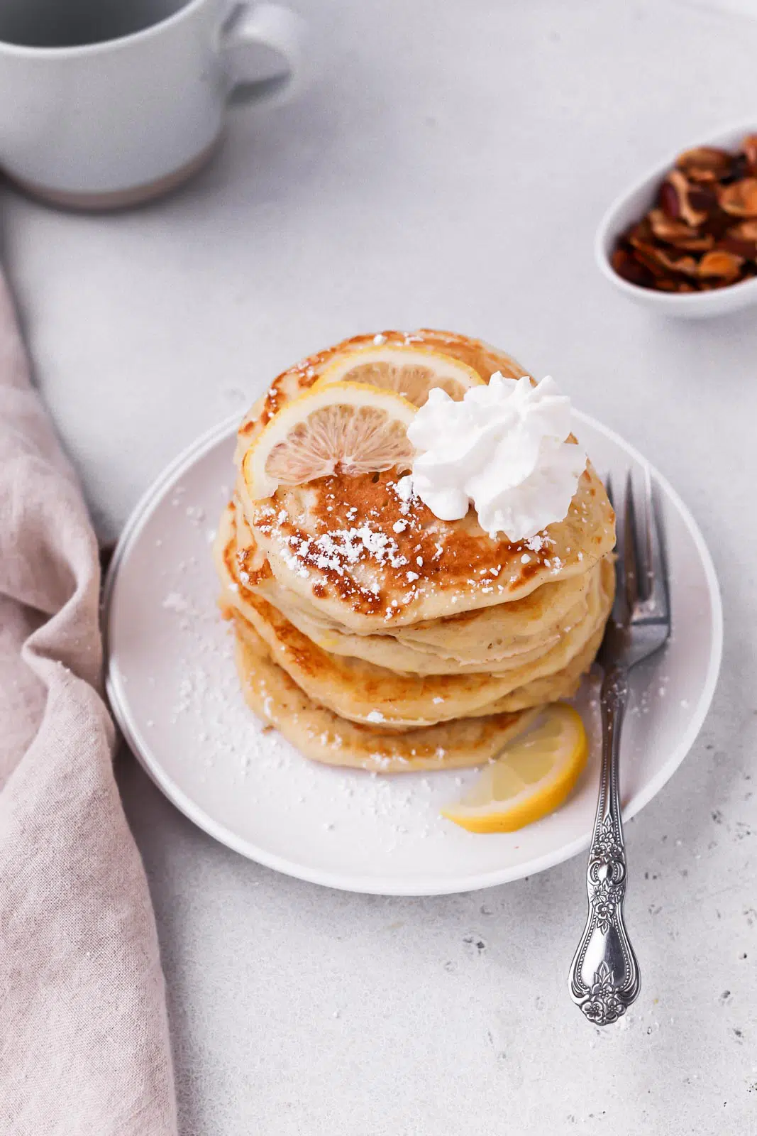 whipped cream and powdered sugar on pancakes