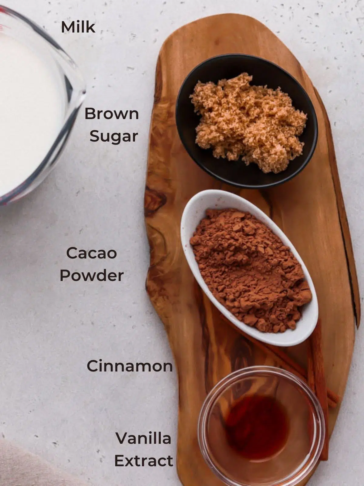 ingredients for hot chocolate: cacao powder, cinnamon and vanilla