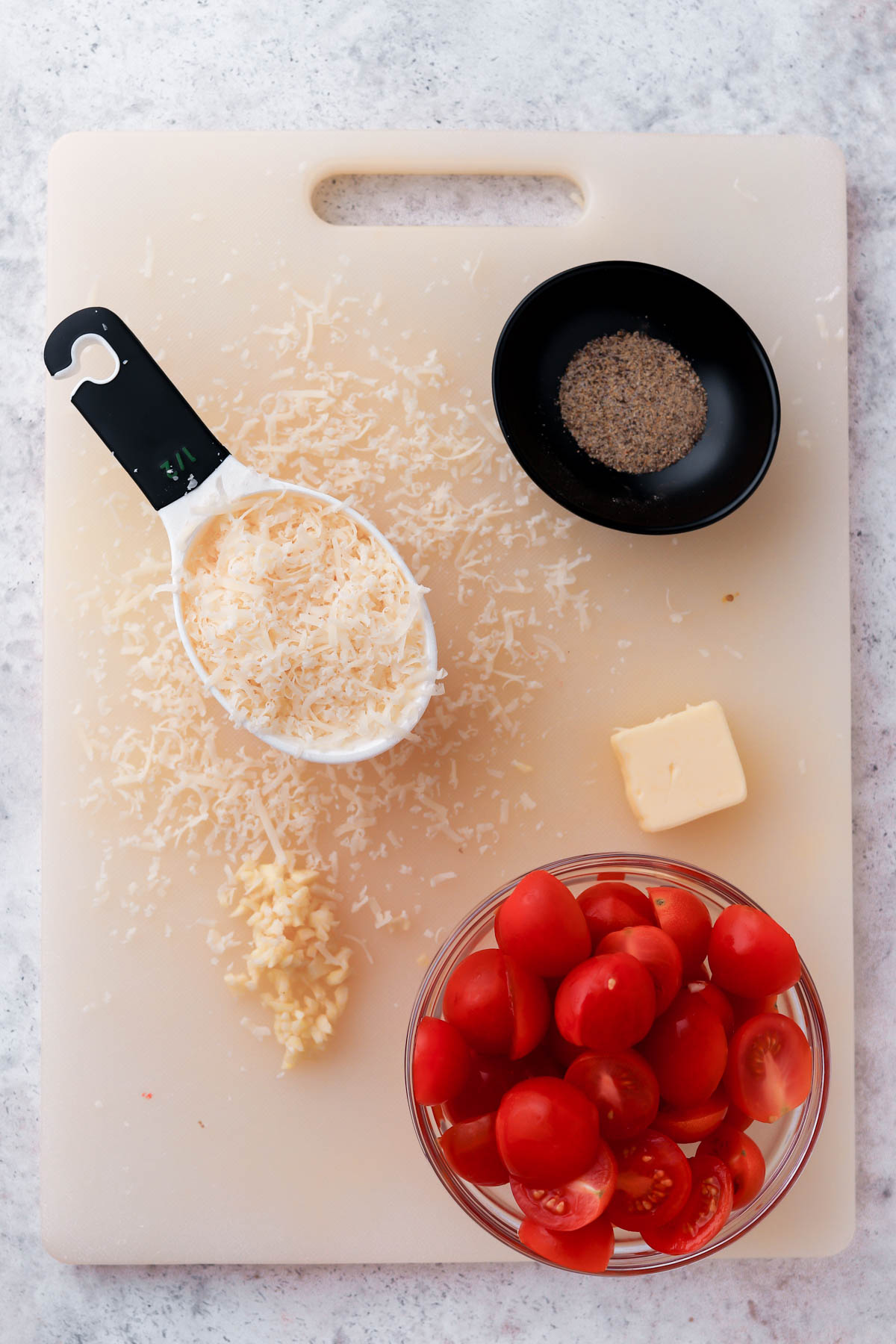 freshly grated parmesan cheese, butter, minced garlic and sliced tomatoes