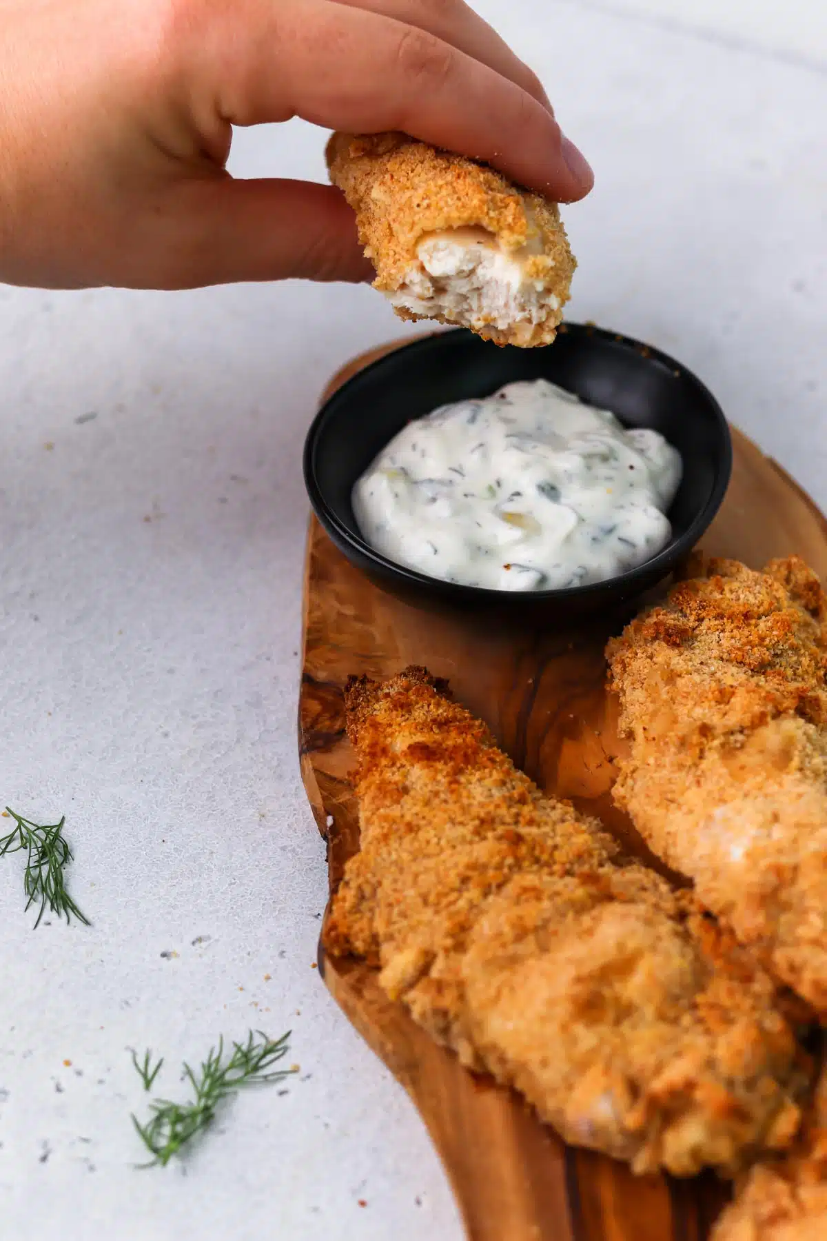 chicken tender dunked in tzatziki