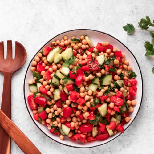 Mediterranean Chickpea Salad with tongs