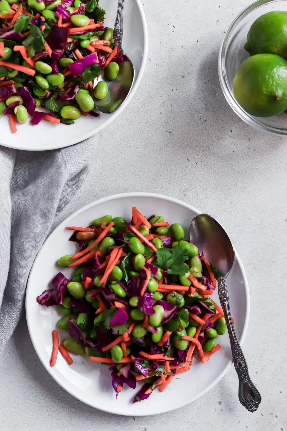 Edamame salad on a plate with spoon.